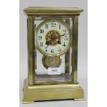 An early 20th Century French brass cased four glass mantel clock with eight day movement striking on