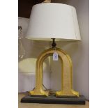 A pair of 20th Century gilt and yellow painted table lamps of inverted 'U' form, raised on