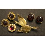 A silver gilt and carbuncle garnet set brooch designed as a floral spray, and a pair of silver
