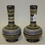 A pair of Doulton Lambeth stoneware bottle vases, circa 1882, each decorated with relief bands of