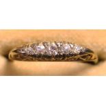 A gold and diamond set five stone ring, mounted with a row of graduated cushion shaped diamonds, the
