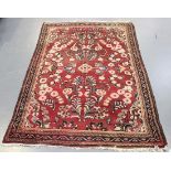 A Hamadan rug, North-west Persia, early 20th Century, the red field with overall sprays of