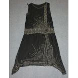 An Art Deco black crêpe cocktail dress with applied bead decoration, length approx 97cm, together