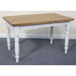 A Victorian stripped and painted pine kitchen table, fitted with a single drawer, on turned tapering