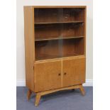 A mid-20th Century oak bookcase, fitted with sliding glass doors above parquetry veneered doors,