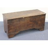 An early 18th Century oak coffer with a hinged lid and applied brass key escutcheon, on bracket