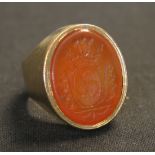 A 9ct gold mounted oval cornelian set signet ring, crest and initial engraved.