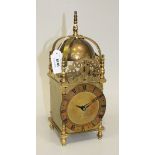 A 20th Century brass lantern style timepiece with eight day drum cased movement, the chapter ring