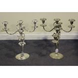 A pair of modern reproduction plated five light candelabra, raised on oval bases, height approx