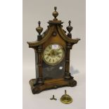 A late 19th Century German walnut mantel clock with eight day movement striking on a gong, the