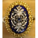 A gold, diamond, sapphire and blue enamelled ring of oval design, claw set with the circular cut