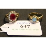 A gold, red and colourless gem set oval cluster ring, detailed '9ct' (one colourless gem lacking),