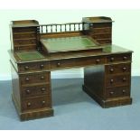A mid-Victorian mahogany twin pedestal desk, the gallery back fitted with a hinged writing slope