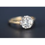 A gold, platinum and diamond single stone ring, claw set with a cushion shaped diamond.