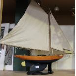 A 20th Century wooden pond yacht with cloth sails and blue painted hull, height approx 88cm,