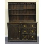 A George V Carolean Revival oak dresser with shelf back, the base fitted with a cupboard and three