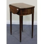 An early 19th Century mahogany oval drop-flap work table with chequer stringing, fitted with a