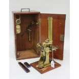 A 19th Century lacquered brass monocular microscope by 'L, Casella... London', with rack and