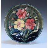 A Moorcroft pottery Freesia pattern circular bowl, 1928-49, the base interior decorated with a spray