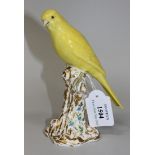 A Royal Worcester canary, post 1950, modelled by Gertner, the yellow bird perched on a gilt and