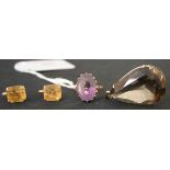 A gold and amethyst single stone ring, claw set with an oval cut amethyst, a gold mounted drop