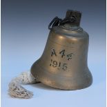 A brass ship's bell, engraved 'A 44 1915', diameter approx 20cm, with chain link suspension and