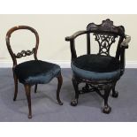 A Victorian style reproduction mahogany tub back armchair, the carved scroll back rail above a