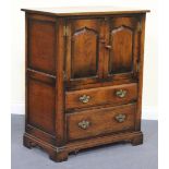 A late 20th Century Jacobean style oak side cabinet by Titchmarsh and Goodwin, fitted with a pair of