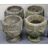 A set of four 20th Century cast composition stone planters with Greek key borders and grape