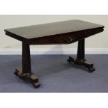A William IV mahogany library table, the flame veneered rectangular top above a shaped and floral