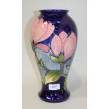 A Moorcroft pottery Pink Magnolia pattern vase, 1970s, the baluster body with blue glazed ground,