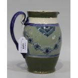 A James Macintyre & Co. Guildhall jug, 1904-13, decorated with blue glazed daisy garlands against