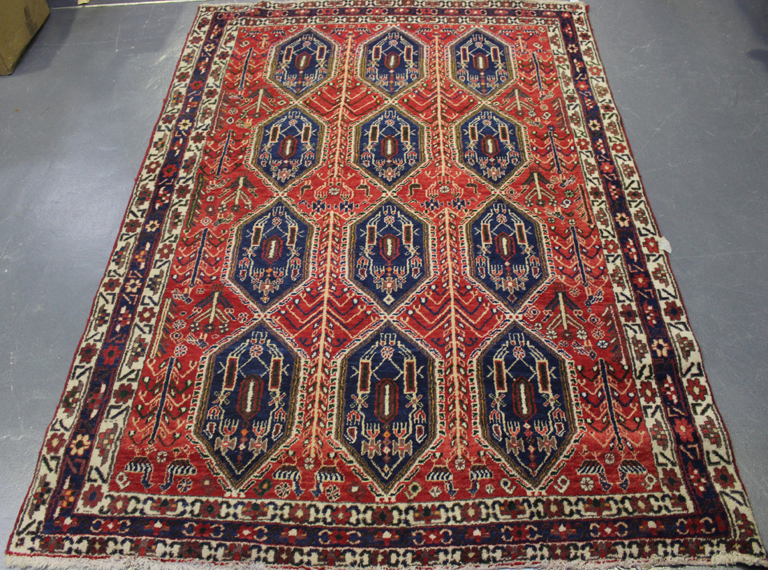 A Sirjan rug, South Persia, mid-20th Century, the red field with three columns of four blue