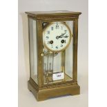 An early 20th Century French brass cased four glass mantel clock, with eight day movement striking