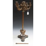 A late 19th Century gilt spelter five branch candelabrum, the reeded stem above claw feet and a