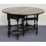 An 18th Century and later oak gateleg dining table, fitted with a single drawer, on turned and block