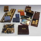 A collection of various early 20th Century games, including two cribbage boards, dominoes and