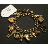 A 9ct gold faceted curblink charm bracelet, on a 9ct gold heart shaped clasp, fitted with a
