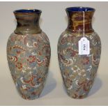 A pair of Doulton Lambeth Slaters Patent stoneware vases, of elongated ovoid form with flared necks,