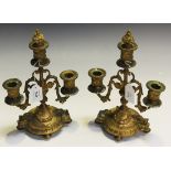 A pair of late 19th Century French cast ormolu twin branch three light candelabra, each with berried