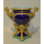 A Mintons majolica jardinière, circa 1875, the high shouldered cobalt blue glazed body flanked by