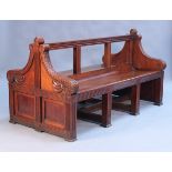 A mid-Victorian walnut double-sided gallery bench, the open panel back with a moulded frame above