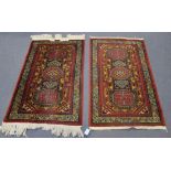 A pair of Turkish rugs, late 20th Century, the blue fields with three hexagonal medallions, within