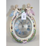 A Meissen porcelain strut timepiece, late 19th Century, the engine turned silvered dial with later