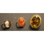 A gold ring, claw set with a large oval cut citrine, detailed '18ct', a gold ring, mounted with an