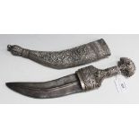 A Middle Eastern white metal mounted jambia with curved double edged blade, length approx 19.5cm, in