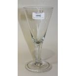 An 18th Century style wine glass, probably 19th Century, the trumpet bowl raised on a teared plain