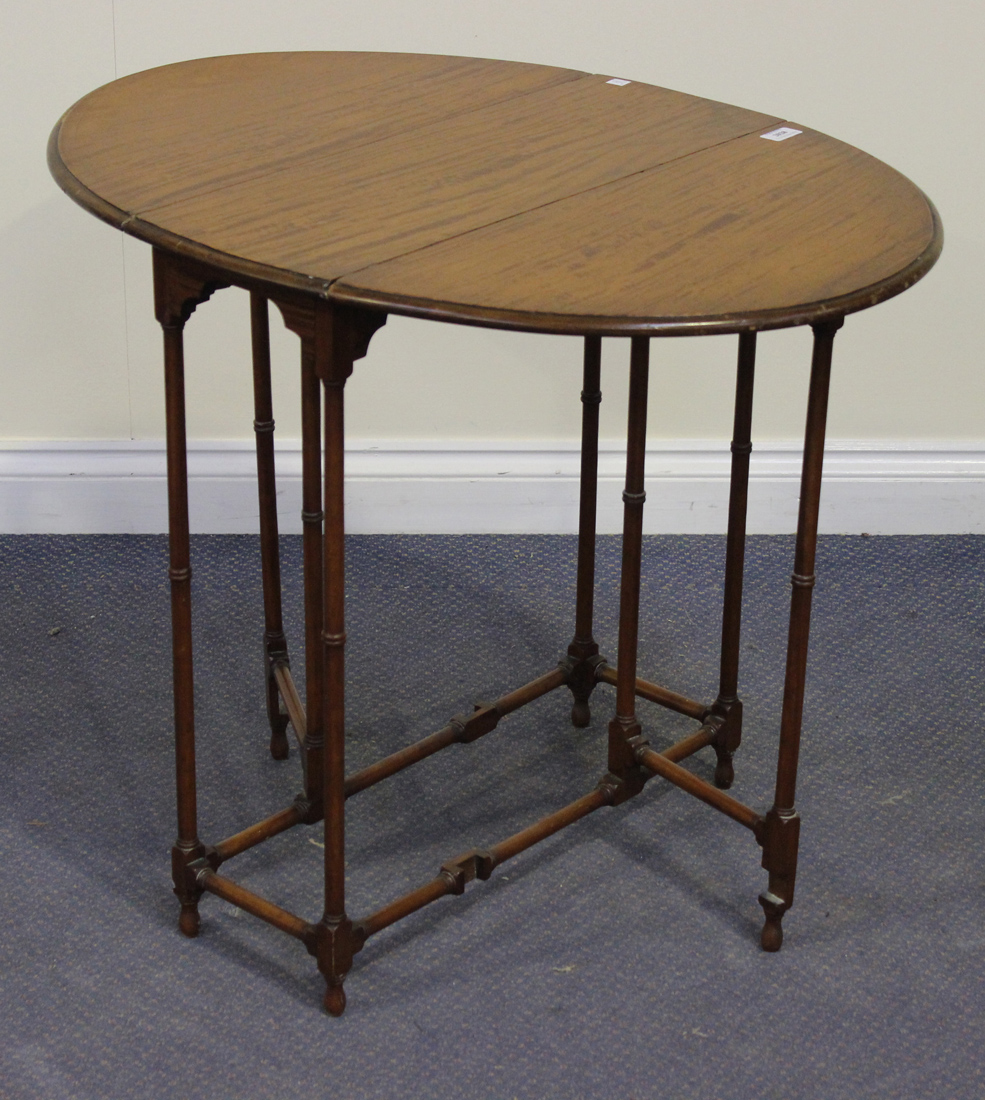 An Edwardian satinwood spider Sutherland table, with two drop leaves, on turned supports, height