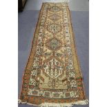 A North-west Persian runner, early 20th Century, the camel field with a column of five hooked