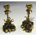A pair of mid-19th Century ormolu and patinated bronze candlesticks with naturalistic leaf cast